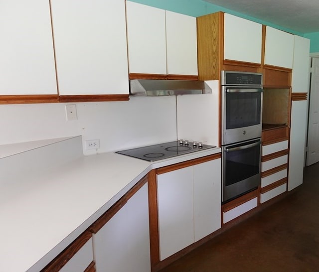 600 Daily St, Jasper, TX 75951 - kitchen with double oven, black electric cooktop, range hood, light countertops, and white cabinets