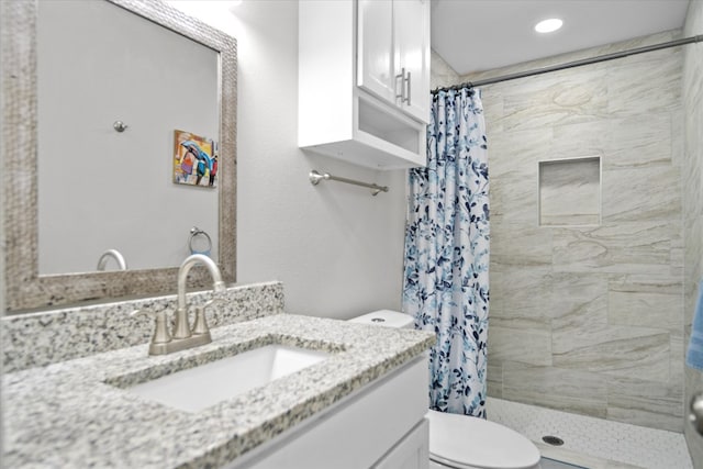 bathroom with vanity, toilet, and curtained shower