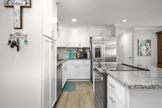 kitchen featuring stainless steel appliances, white cabinetry, light wood-type flooring, and light stone counters