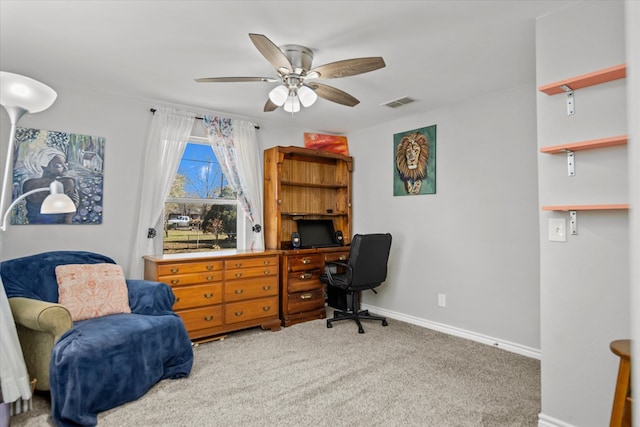 carpeted office space with ceiling fan