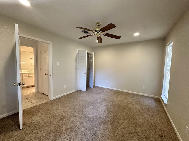 unfurnished bedroom with light colored carpet and ceiling fan