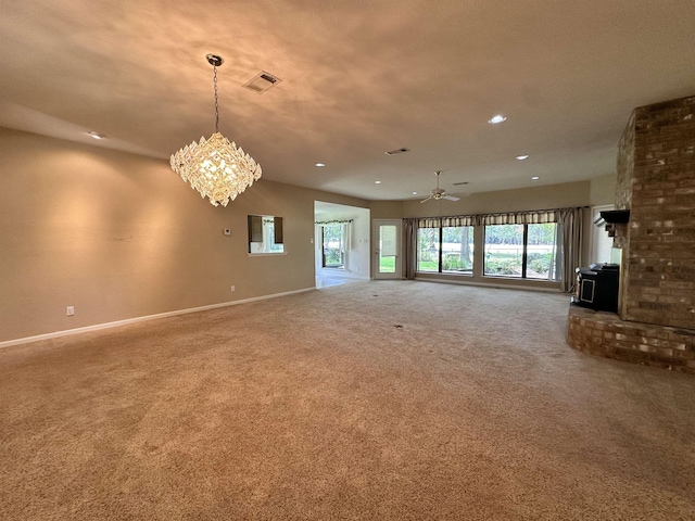 unfurnished living room with carpet flooring and an inviting chandelier