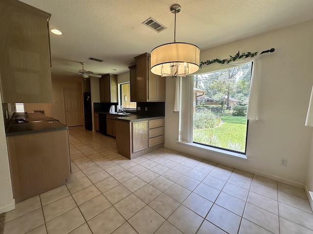 kitchen with pendant lighting, sink, ceiling fan, a textured ceiling, and light tile patterned flooring