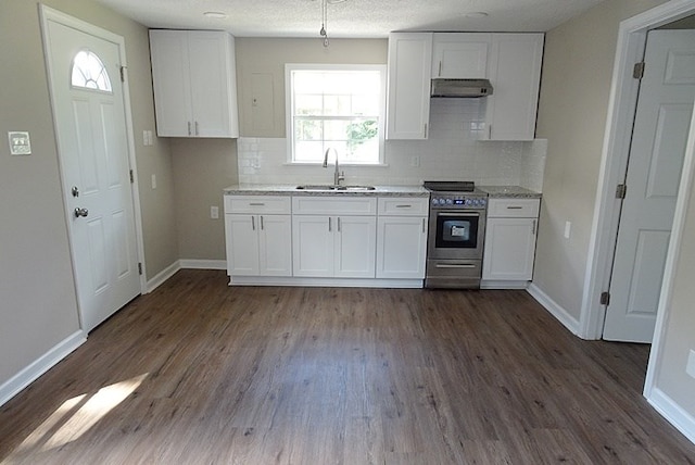 kitchen featuring white cabinets, decorative backsplash, stainless steel electric range oven, and sink