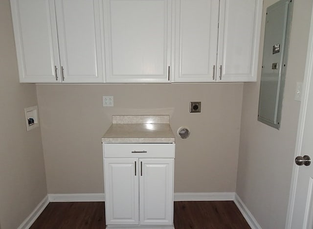 laundry area with cabinets, electric dryer hookup, dark hardwood / wood-style flooring, electric panel, and hookup for a washing machine