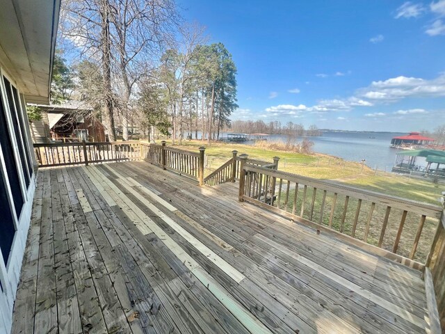 deck featuring a yard and a water view