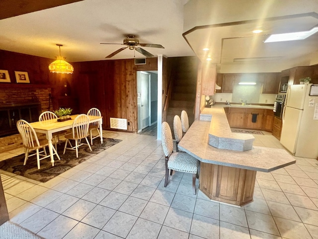 interior space featuring oven, visible vents, a peninsula, and light countertops