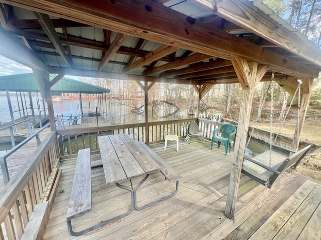 wooden deck featuring a water view and a dock