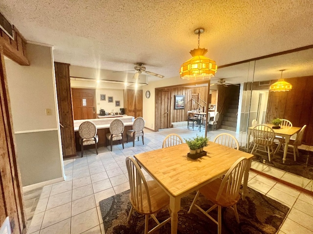 dining space with light tile patterned floors, stairs, and a ceiling fan