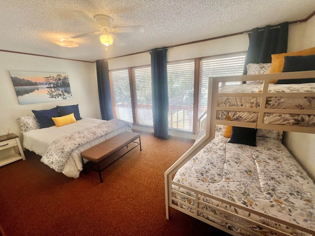 carpeted bedroom featuring a textured ceiling and ceiling fan