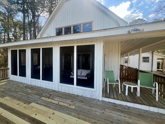 wooden terrace featuring a sunroom