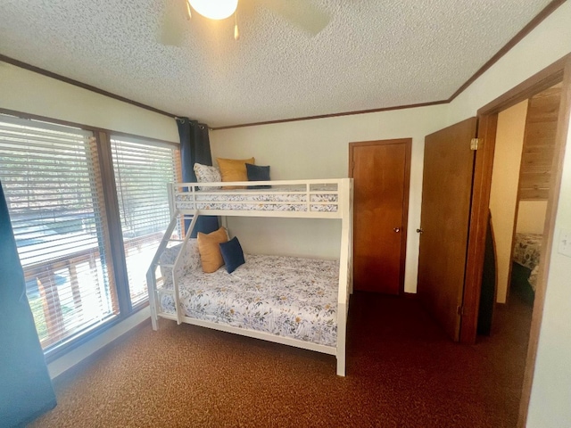 bedroom with a textured ceiling, a ceiling fan, carpet, and ornamental molding