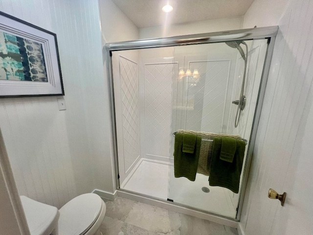 full bathroom with toilet and a stall shower