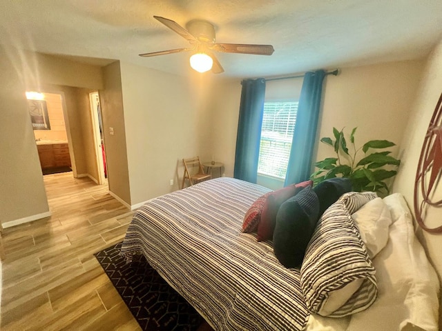 bedroom featuring ceiling fan, baseboards, and light wood-style flooring