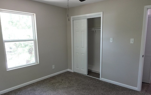 1604 Lilac Ave, Lufkin, TX 75901 - unfurnished bedroom with baseboards, dark carpet, and a closet