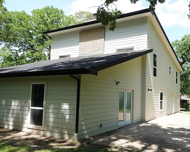 1604 Lilac Ave, Lufkin, TX 75901 - rear view of property featuring french doors, driveway, and an attached garage