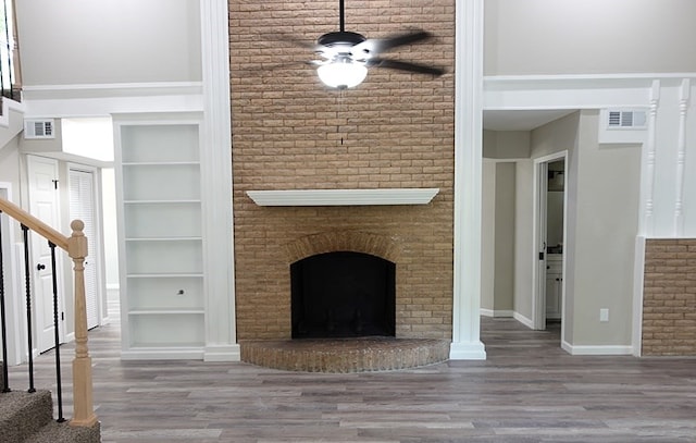 1604 Lilac Ave, Lufkin, TX 75901 - unfurnished living room featuring stairs, wood finished floors, built in features, and a towering ceiling