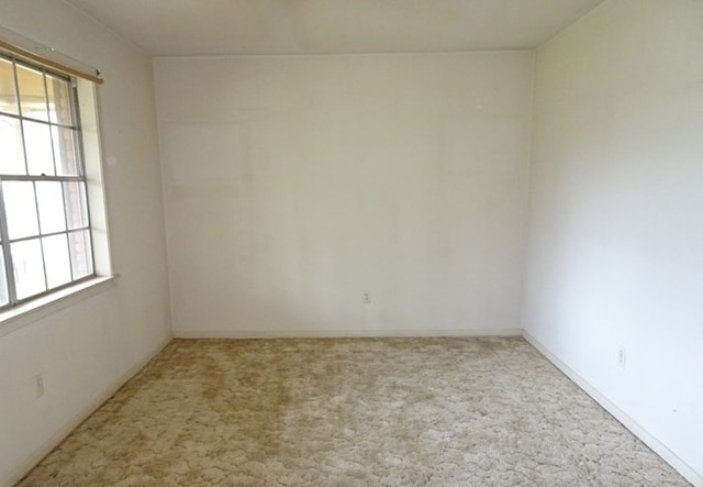 carpeted spare room with a healthy amount of sunlight