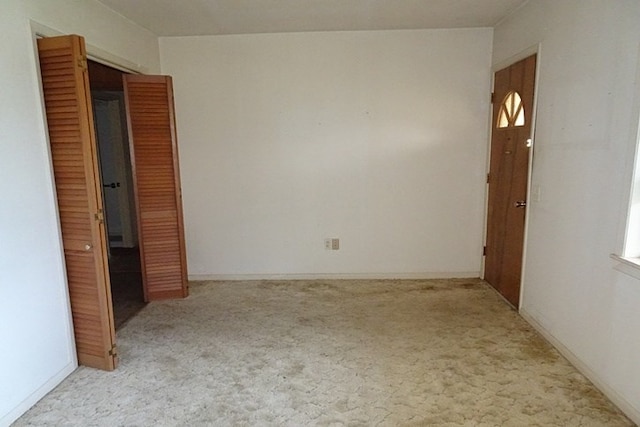 unfurnished room with light carpet