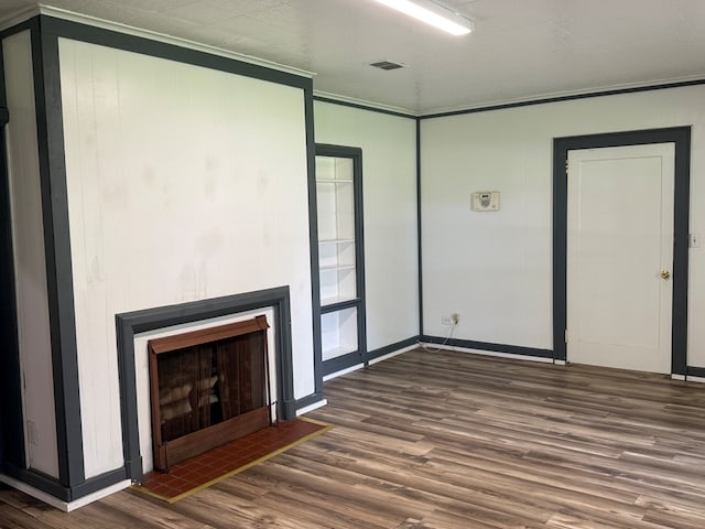 730 Kiln St, Lufkin, TX 75904 - unfurnished living room with wood finished floors, a fireplace, baseboards, and ornamental molding