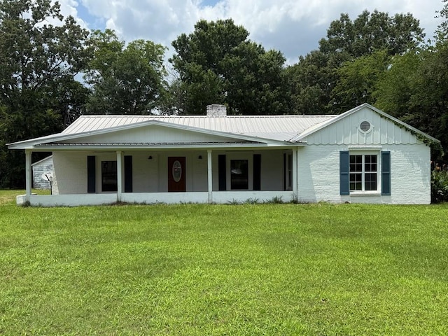 730 Kiln St, Lufkin, TX 75904 - view of front facade featuring a front yard, a chimney, and metal roof