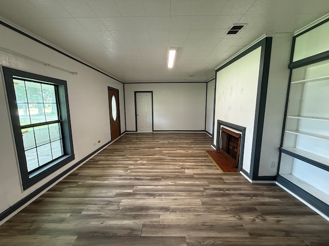 730 Kiln St, Lufkin, TX 75904 - unfurnished room with a fireplace with flush hearth and dark wood-type flooring