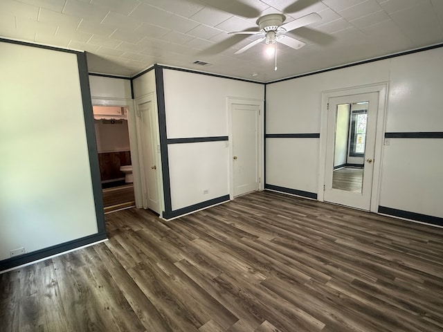 730 Kiln St, Lufkin, TX 75904 - unfurnished bedroom with dark wood-type flooring, baseboards, and connected bathroom