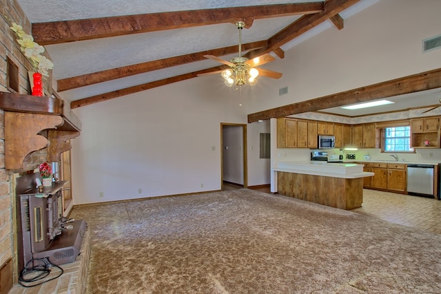 kitchen featuring high vaulted ceiling, ceiling fan, appliances with stainless steel finishes, beamed ceiling, and kitchen peninsula