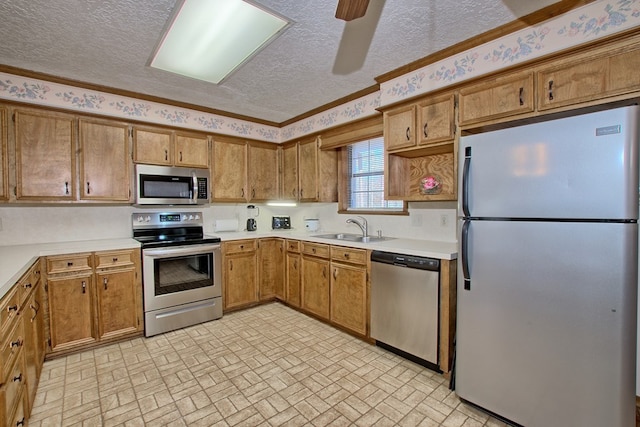 kitchen with ceiling fan, sink, a textured ceiling, and appliances with stainless steel finishes