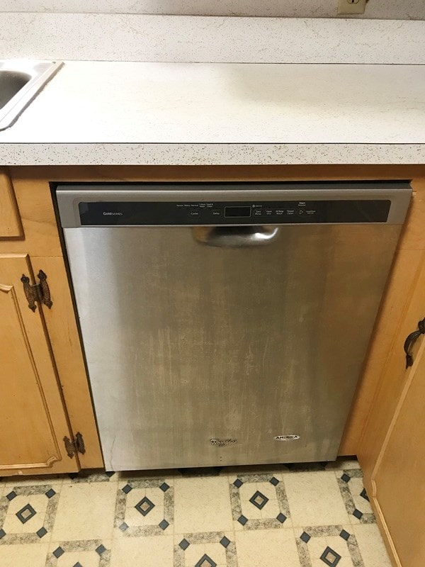 365 Roughrider Dr, Center, TX 75935 - kitchen view of stainless steel dishwasher, brown cabinets, a sink, and light flooring
