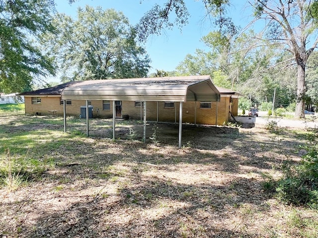 365 Roughrider Dr, Center, TX 75935 - rear view of house featuring a carport