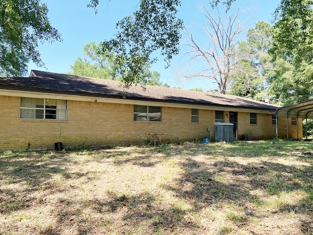365 Roughrider Dr, Center, TX 75935 - rear view of house featuring brick siding and a detached carport