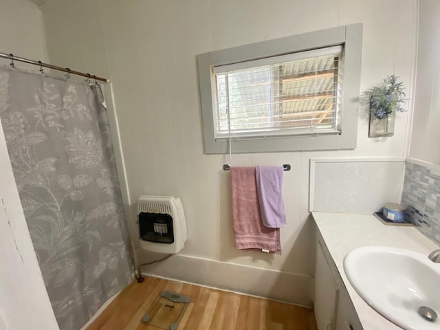 bathroom with vanity, wood-type flooring, and heating unit