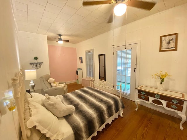 bedroom with ceiling fan and dark wood-type flooring