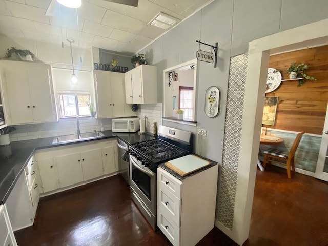 5003 Lotus Ln, Lufkin, TX 75904 - kitchen featuring appliances with stainless steel finishes, a sink, tasteful backsplash, and white cabinets