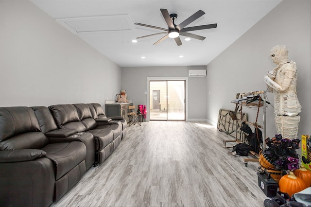 living room featuring a wall unit AC and light hardwood / wood-style flooring