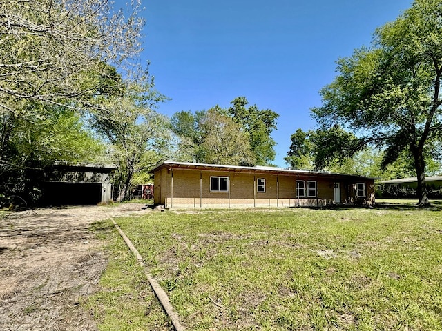 rear view of property featuring a yard