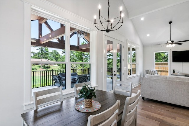 dining area featuring hardwood / wood-style floors, high vaulted ceiling, french doors, ceiling fan with notable chandelier, and beamed ceiling