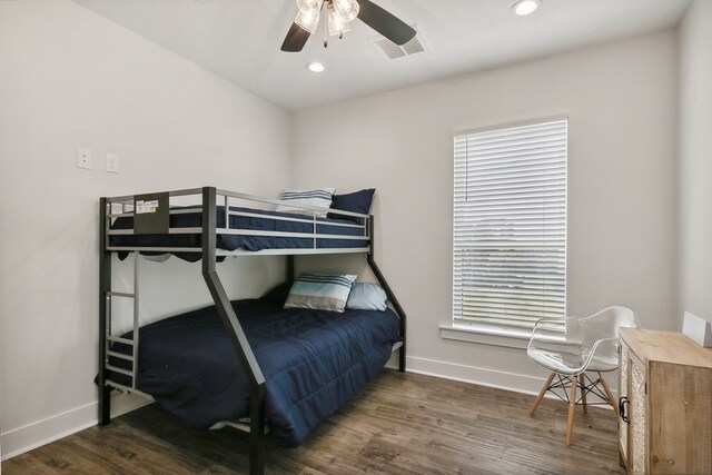 bedroom with ceiling fan and dark hardwood / wood-style floors