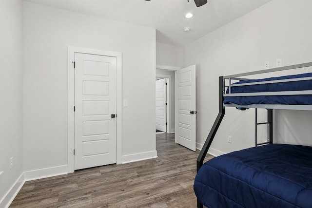 bedroom featuring ceiling fan, wood-type flooring, and lofted ceiling