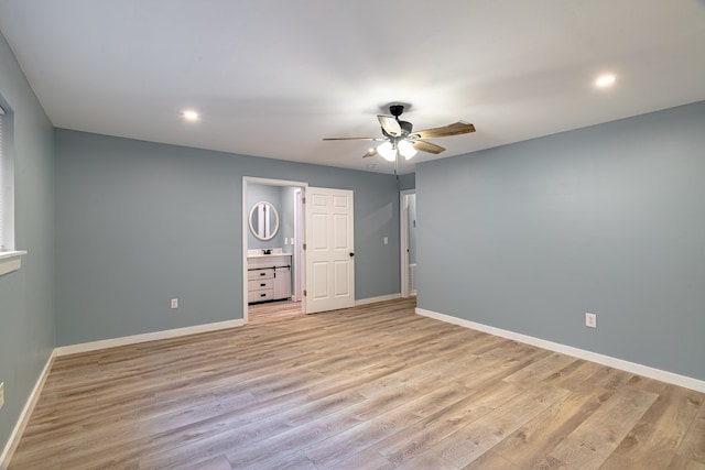 unfurnished bedroom with connected bathroom, light hardwood / wood-style flooring, ceiling fan, and sink