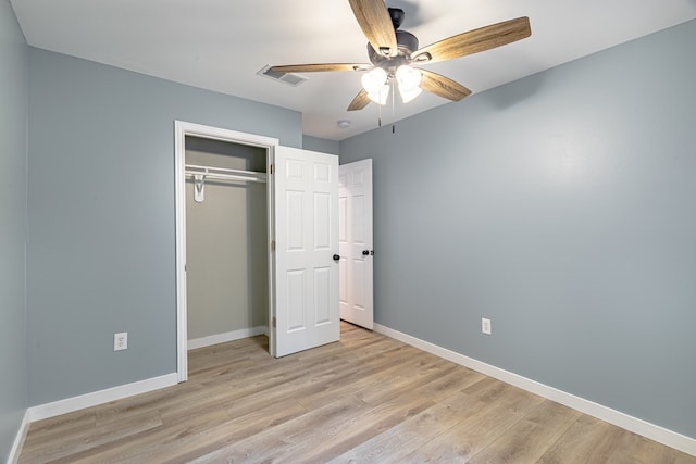 unfurnished bedroom with ceiling fan, a closet, and light hardwood / wood-style flooring