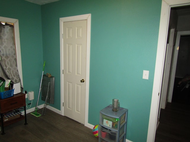 bedroom with dark wood-type flooring