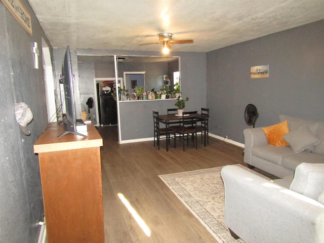 living room featuring ceiling fan and hardwood / wood-style floors