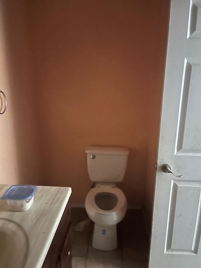 bathroom with tile patterned floors, vanity, and toilet