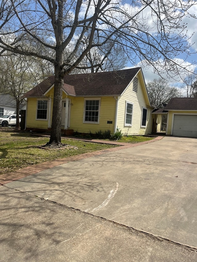 view of front of home with an attached garage, driveway, and a front yard