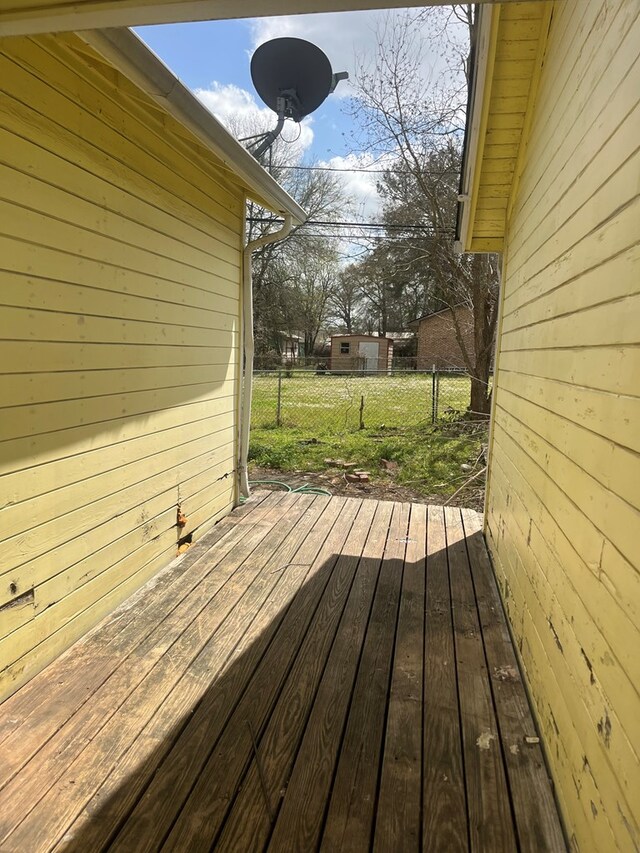 wooden terrace with fence and a lawn
