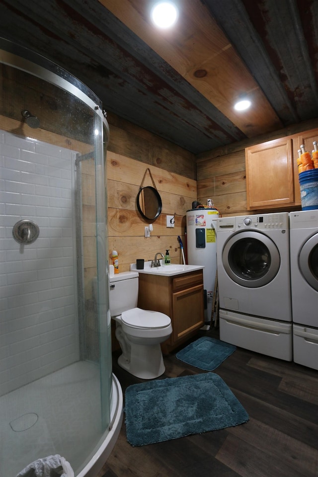 full bathroom featuring a shower stall, wood walls, vanity, independent washer and dryer, and electric water heater