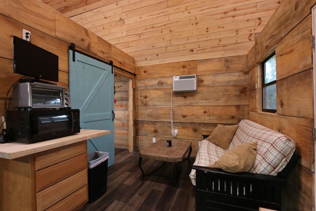 living area with a barn door, an AC wall unit, wooden walls, wood ceiling, and dark wood-style floors