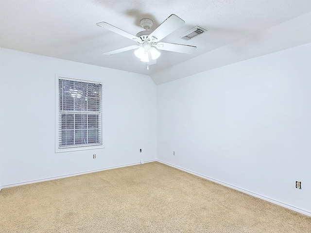 unfurnished room with ceiling fan and carpet